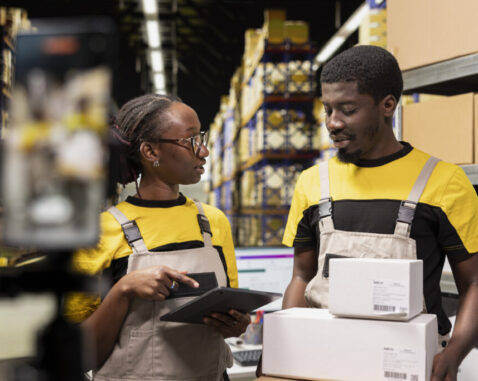 E-commerce team recording commercial ad in organized retail warehouse